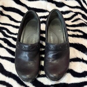 Dansko Black Leather Slip-On Clogs with Stud Accent